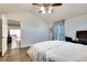 Bedroom featuring light grey walls, ceiling fan, light wood-look flooring, and a view into the living room at 2312 Wayside Ne Dr, Brookhaven, GA 30319