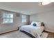 A bedroom with two windows, hardwood flooring, and an area rug at 2312 Wayside Ne Dr, Brookhaven, GA 30319