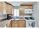 Well-lit kitchen featuring wood cabinets, essential appliances, and tile flooring at 2312 Wayside Ne Dr, Brookhaven, GA 30319
