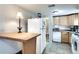 Efficient kitchen featuring white appliances, wooden cabinets, and tile flooring at 2312 Wayside Ne Dr, Brookhaven, GA 30319