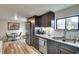 Well-lit kitchen with stainless steel appliances, dark cabinets, and granite countertops with a breakfast nook to the side at 2312 Wayside Ne Dr, Brookhaven, GA 30319