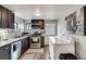 Bright kitchen featuring stainless steel appliances, tile backsplash, and modern cabinets, plus an adjacent washer/dryer at 2312 Wayside Ne Dr, Brookhaven, GA 30319