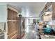 Galley kitchen leads to dining area, featuring stainless appliances and wood floors at 2312 Wayside Ne Dr, Brookhaven, GA 30319