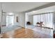 A large living room with light grey walls, hardwood and tile flooring, and multiple seating areas at 2312 Wayside Ne Dr, Brookhaven, GA 30319