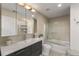 Well-lit bathroom featuring sleek vanity, modern fixtures, and glass-enclosed bathtub and shower at 3300 Windy Ridge Se Pkwy # 922, Atlanta, GA 30339