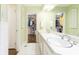 Bathroom featuring double sinks, a large mirror, and a view into the walk-in closet at 4095 Glen Devon Nw Dr, Atlanta, GA 30327