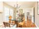 Cozy dining area with a glass-top table, a decorative chandelier, and terra cotta tile flooring at 4095 Glen Devon Nw Dr, Atlanta, GA 30327