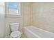 Bright bathroom with a white toilet and tub shower combination at 4808 Albany Way, Atlanta, GA 30331