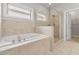 Bright bathroom showcasing a soaking tub and a glass-enclosed shower at 4808 Albany Way, Atlanta, GA 30331
