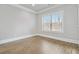 A bright bedroom featuring a hardwood floor and ample natural light from the window at 4808 Albany Way, Atlanta, GA 30331