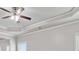 Living room showcasing a ceiling fan, crown molding, and natural light from the windows at 4808 Albany Way, Atlanta, GA 30331