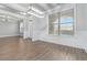 Bright dining room featuring hardwood floors, white trim, a modern light fixture and large window at 4808 Albany Way, Atlanta, GA 30331