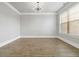 Bright dining room featuring hardwood floors, white trim, a modern light fixture and large window at 4808 Albany Way, Atlanta, GA 30331