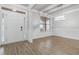 Bright dining room with hardwood floors, white trim, a modern chandelier, and a large window at 4808 Albany Way, Atlanta, GA 30331