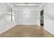 Dining room featuring hardwood floors, white trim, a modern light fixture and large window at 4808 Albany Way, Atlanta, GA 30331