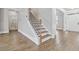 Bright entryway features wood floors, a staircase with a black iron rail, and a white front door at 4808 Albany Way, Atlanta, GA 30331