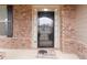 Elegant front door with glass panel and sidelights, complemented by brick facade and black shutters at 4808 Albany Way, Atlanta, GA 30331