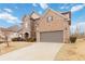 Beautiful brick home with an attached two-car garage and a spacious driveway, set against a clear blue sky at 4808 Albany Way, Atlanta, GA 30331