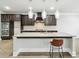 Kitchen with granite counters, stainless appliances, and a large island with bar seating and pendant lights at 4808 Albany Way, Atlanta, GA 30331