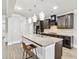 Kitchen featuring dark cabinets, granite countertops, a large island and modern pendant lighting at 4808 Albany Way, Atlanta, GA 30331