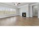 Spacious living room with wood floors, a ceiling fan, a fireplace and large windows providing plenty of natural light at 4808 Albany Way, Atlanta, GA 30331
