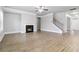 View of the open-concept living space with fireplace, wood-look floors, and a staircase at 4808 Albany Way, Atlanta, GA 30331