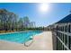 Relaxing community pool with clear blue water, surrounded by trees and manicured landscaping at 4808 Albany Way, Atlanta, GA 30331