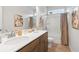Bright bathroom with double sink vanity, a shower and bathtub combo, and decorative artwork at 174 Silver Leaf Trl, Douglasville, GA 30134