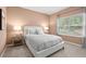 Comfortable bedroom with a large window, soft lighting, and neutral decor at 174 Silver Leaf Trl, Douglasville, GA 30134