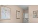 Hallway with neutral walls and artwork, leading to bedrooms with light-filled interiors at 174 Silver Leaf Trl, Douglasville, GA 30134