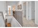 Upstairs hallway with neutral carpet, decorative railing, and access to multiple rooms at 174 Silver Leaf Trl, Douglasville, GA 30134