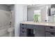 Neutral bathroom featuring gray vanity with marble countertop and a tub-shower with tiled wall at 102 Johnson Ct, Decatur, GA 30030