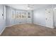 Spacious bedroom with carpeted floors, bright windows, ceiling fan, and white trim at 102 Johnson Ct, Decatur, GA 30030
