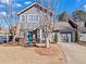 Charming two-story townhouse featuring a brick facade, gray siding, well-manicured lawn and an attached garage at 102 Johnson Ct, Decatur, GA 30030