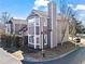 View of the side and rear of a gray townhouse, highlighting its architectural details and surrounding landscaping at 102 Johnson Ct, Decatur, GA 30030