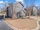 Charming two-story townhouse featuring a brick facade, gray siding, well-manicured lawn and an attached garage at 102 Johnson Ct, Decatur, GA 30030
