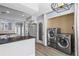 Updated kitchen features stainless steel appliances, dark countertops, an island, and includes laundry appliances at 102 Johnson Ct, Decatur, GA 30030