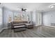 Bright living room with a ceiling fan, large windows, hardwood floors, and stylish furniture, creating a cozy atmosphere at 102 Johnson Ct, Decatur, GA 30030