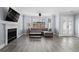 Bright living room with a fireplace, large windows, hardwood floors, and stylish furniture, creating a cozy atmosphere at 102 Johnson Ct, Decatur, GA 30030