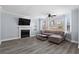 Bright living room with a fireplace, large windows, hardwood floors, and stylish furniture, creating a cozy atmosphere at 102 Johnson Ct, Decatur, GA 30030