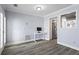 Bright office area features a small desk, light gray walls, and wood-look flooring, with partial view into the kitchen at 102 Johnson Ct, Decatur, GA 30030