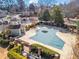 Aerial view of pool covered for the off-season, with nearby clubhouse and green landscaping at 102 Johnson Ct, Decatur, GA 30030
