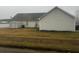 View of the backyard with vinyl siding and storage shed at 10936 Station Dr, Hampton, GA 30228