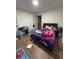 A bedroom with a modern bed frame and a variety of colorful plush toys and playful bedding at 10936 Station Dr, Hampton, GA 30228