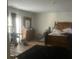 Spacious bedroom featuring hardwood floors and a traditional wooden dresser and bed frame at 10936 Station Dr, Hampton, GA 30228