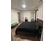 Cozy bedroom with a comfortable black bed and natural light at 10936 Station Dr, Hampton, GA 30228