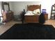 Bedroom with a dark rug and wooden furniture, including a dresser and bed frame, on hardwood floors at 10936 Station Dr, Hampton, GA 30228