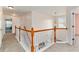 Hallway landing with wood railing, carpet, and nearby open doors at 2540 Lansing Ln, Cumming, GA 30041