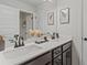 A dual sink bathroom with matching drawers, cabinets, and black faucet fixtures at 4433 Eastbrook Pl, Snellville, GA 30039