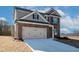 Two-story brick home featuring a two-car garage and long drive with new concrete at 4433 Eastbrook Pl, Snellville, GA 30039